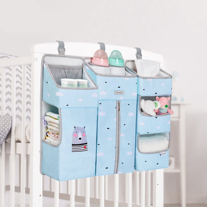 Maroon Chronos baby crib organizer with multiple pockets for nursery decor, hanging on a crib in a nursery setting