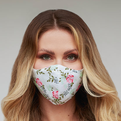 Light green floral face mask for women by Cyan Poppy, featuring a soft fabric with a vibrant floral pattern.