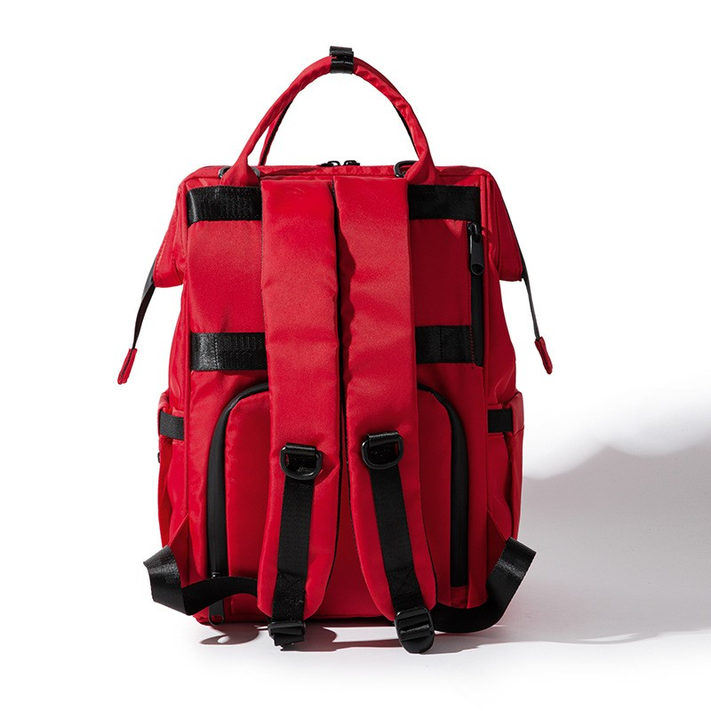 Carmine Juneberry SmartMom Travel+ diaper backpack with multiple compartments, adjustable straps, and baby essentials storage.