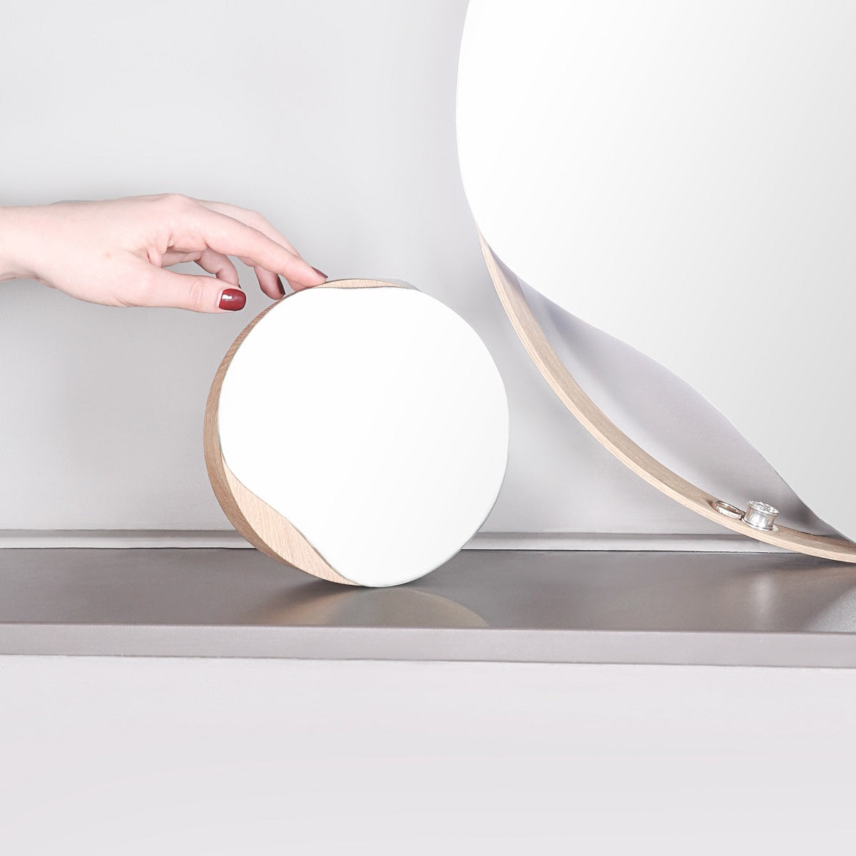 Biotite bathroom cosmetic round mirror with oak wood or black frame, stylish and functional for grooming and decoration.