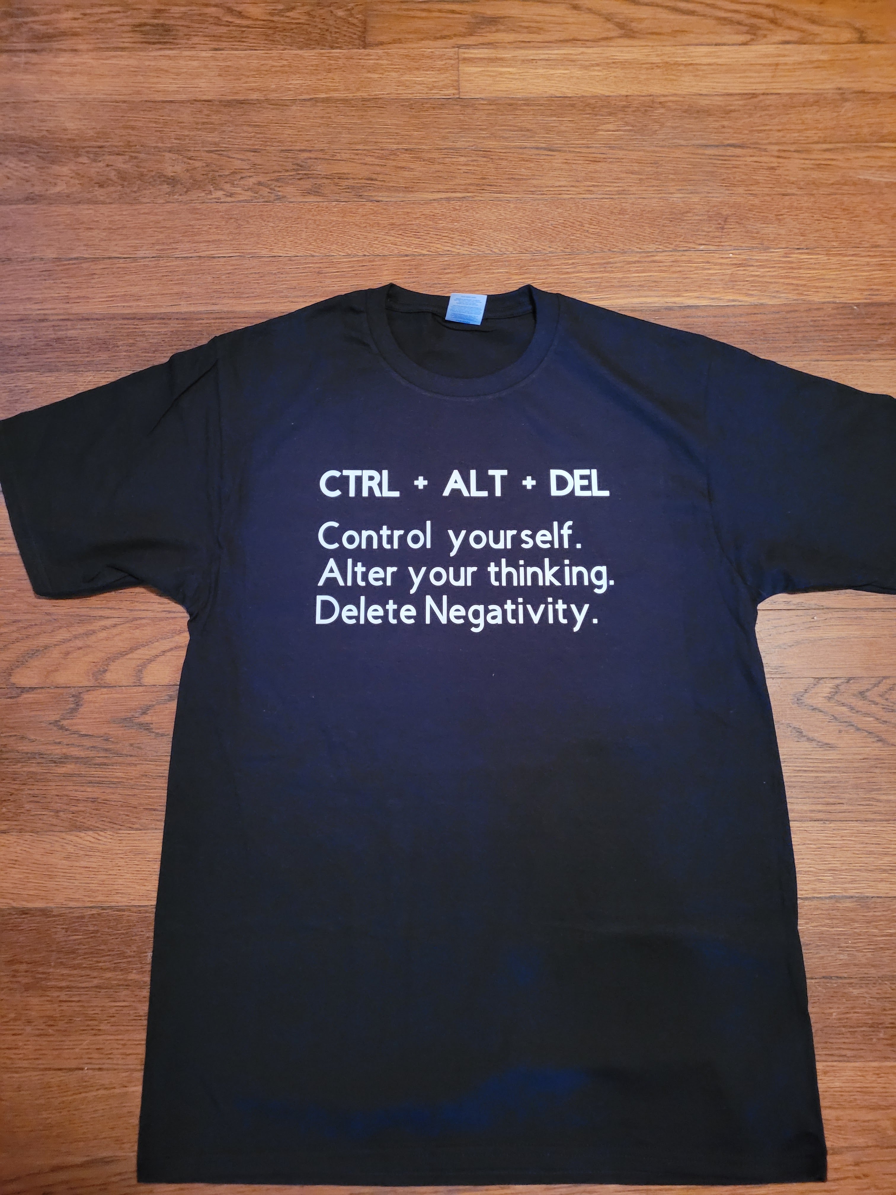 Black adults T-shirt featuring "CTRL + ALT + DELETE" text by Coral Strawberry, casual graphic tee for adults.