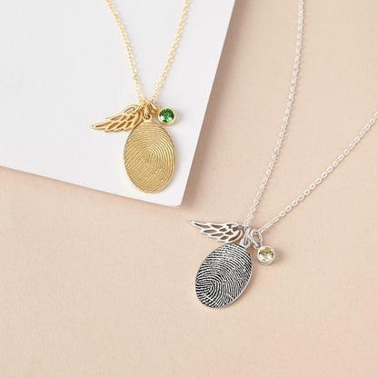 Silver fingerprint necklace with a birthstone charm, personalized fingerprint jewelry by Green Millie, close-up of the pendant.