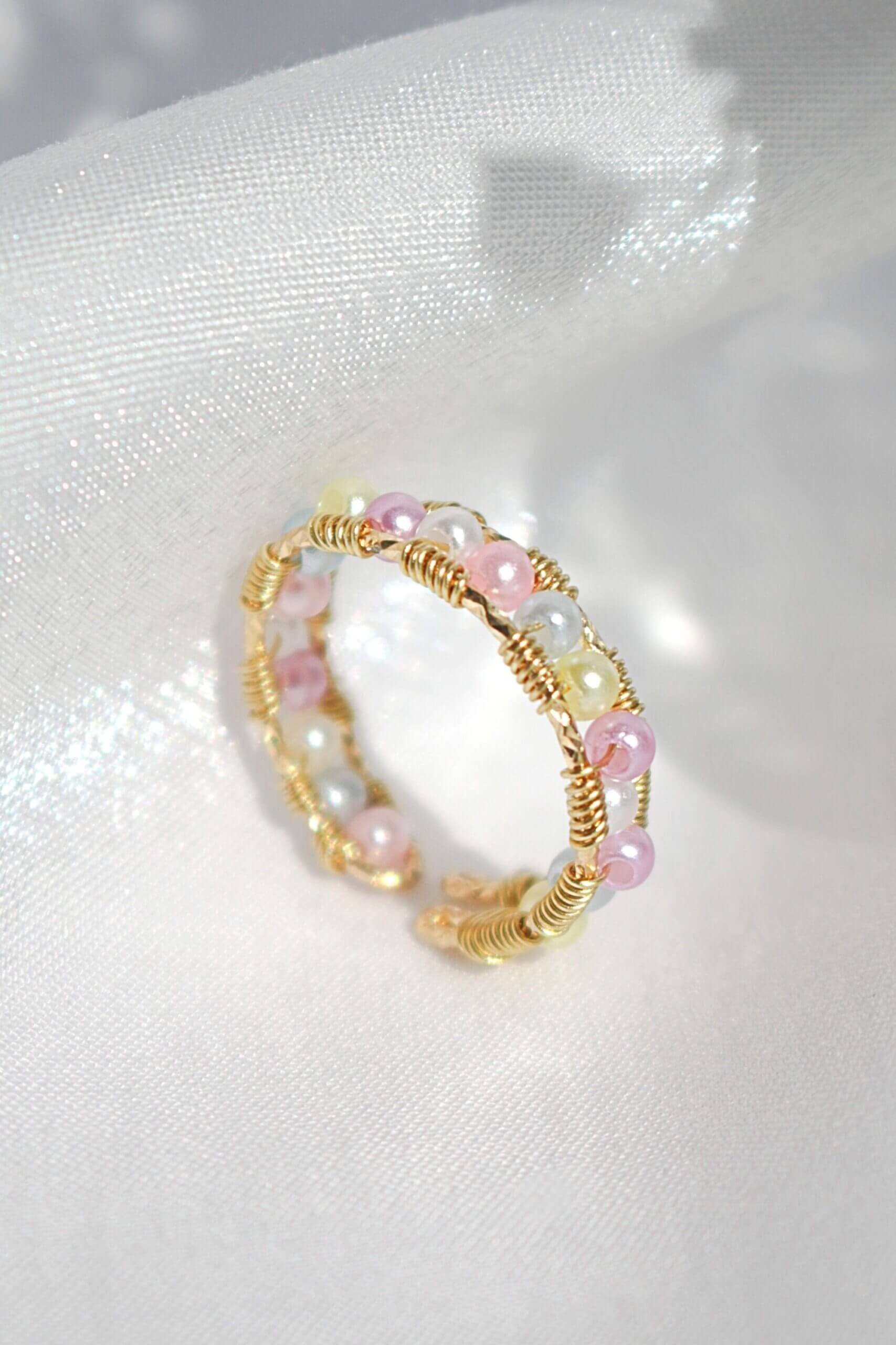 Ultramarine Birch 18K pastel rainbow hand-wired band ring featuring vibrant, multicolored gemstones and intricate craftsmanship.