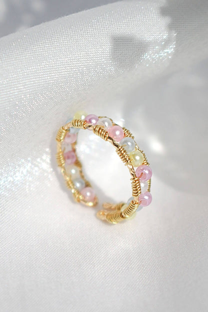 Ultramarine Birch 18K pastel rainbow hand-wired band ring featuring vibrant, multicolored gemstones and intricate craftsmanship.