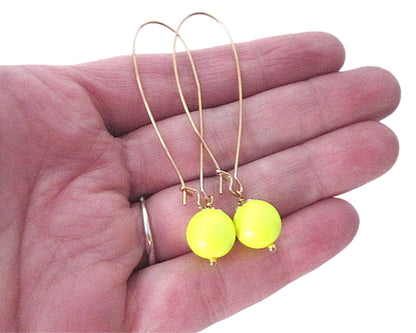 Mint Green Briseis neon bead dangle earrings showing vibrant beads and silver hooks on a plain background.