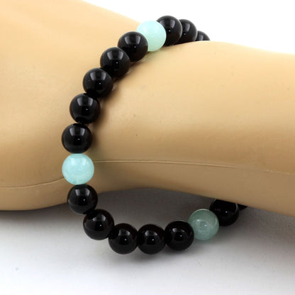 Angelite and black agate bracelet with 8mm beads by Tan Coconut, featuring smooth round stones and adjustable cord.