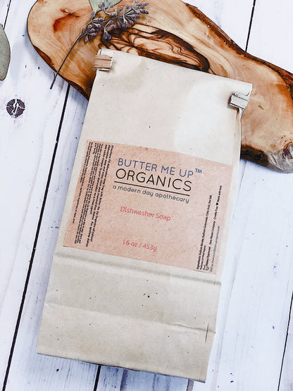White Smokey all natural dishwasher soap in a kitchen setting, showing the eco-friendly detergent container.