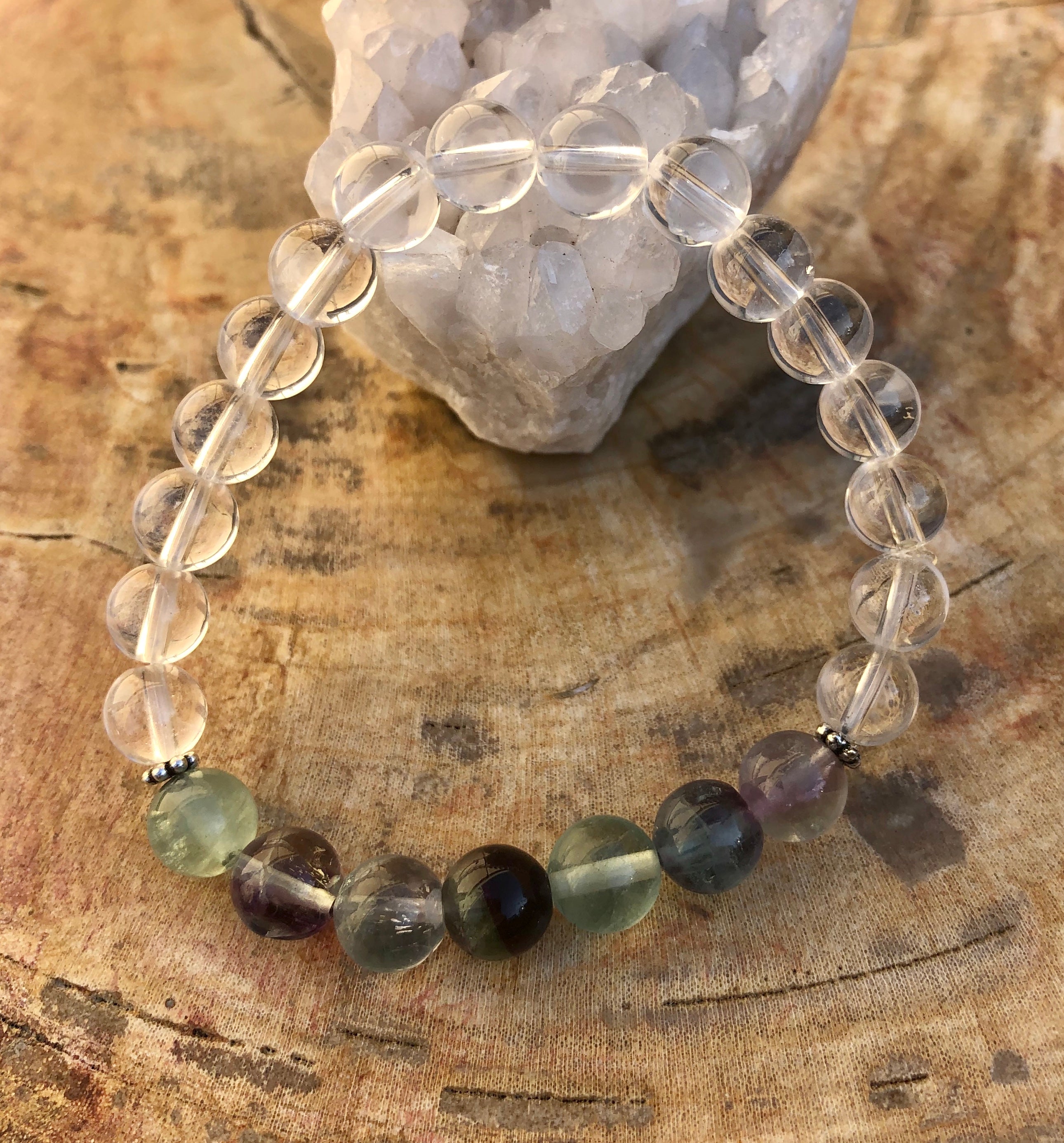 Rainbow fluorite and crystal quartz stretch bracelet with natural gemstones, featuring colorful beads on a flexible elastic band.