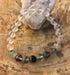Rainbow fluorite and crystal quartz stretch bracelet with natural gemstones, featuring colorful beads on a flexible elastic band.