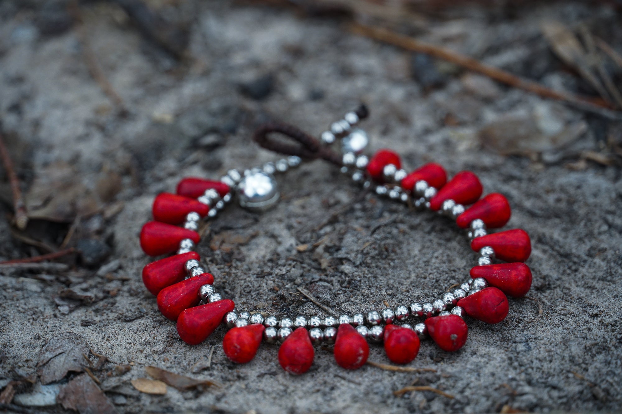 Silver double-stranded boho bracelets with ocean drop charms from Tan Smokey, featuring intricate designs and adjustable clasps.