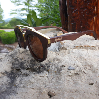Purple Ariadne cherry wood full frame sunglasses with polarized lenses and gold trim, handcrafted and stylish.