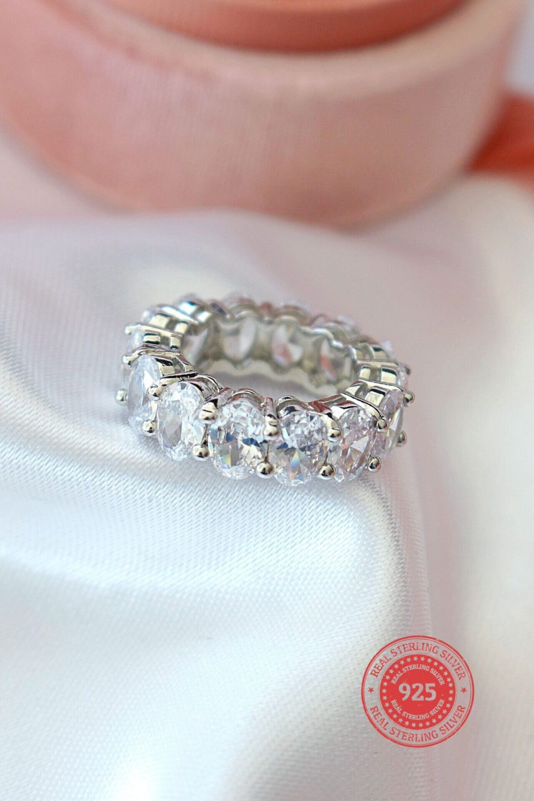 925 silver oval cubic zirconia band ring with sparkling stones, crafted by Ultramarine Birch, showcasing elegant jewelry design.