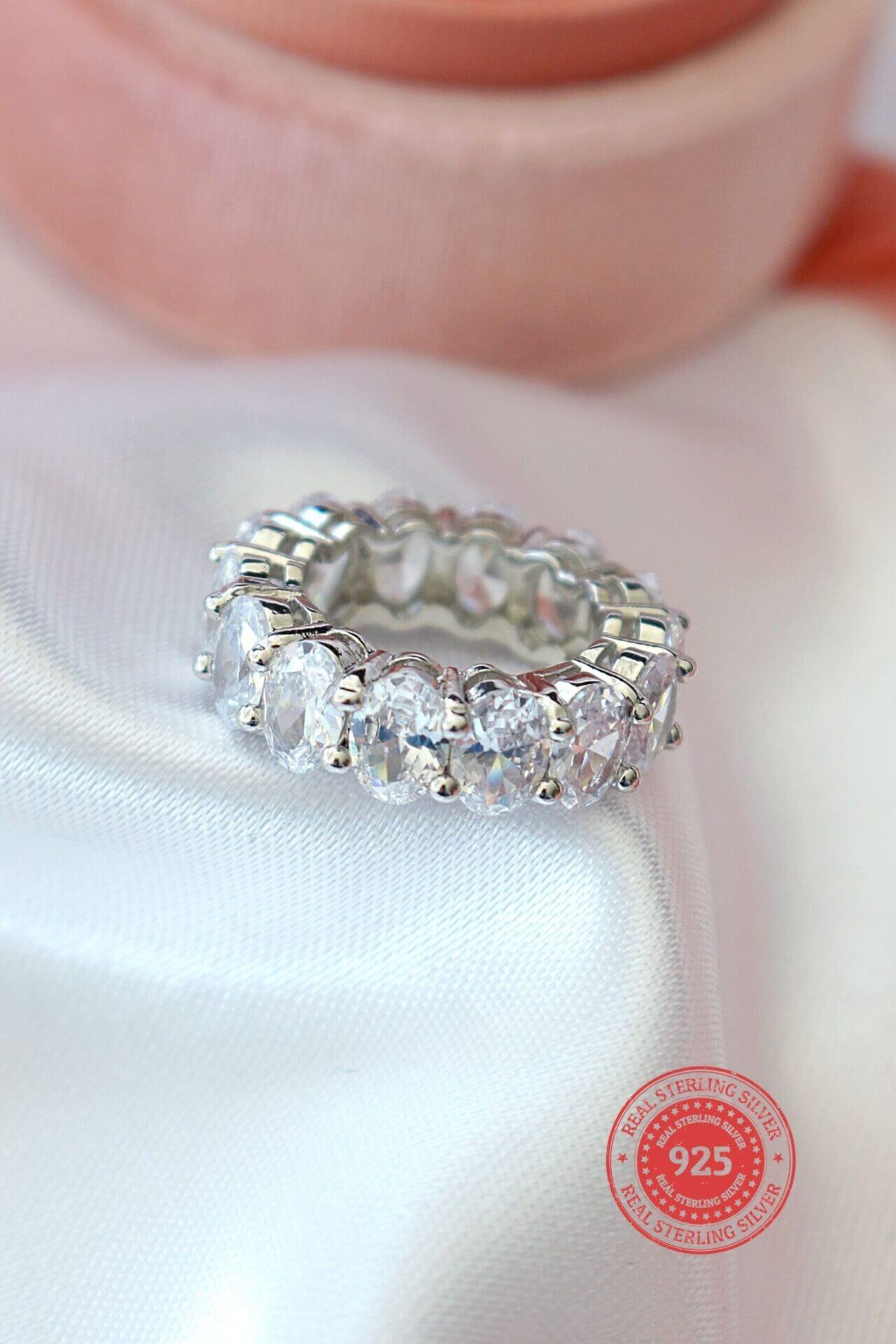 925 silver oval cubic zirconia band ring with sparkling stones, crafted by Ultramarine Birch, showcasing elegant jewelry design.