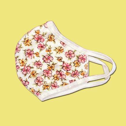 Reusable floral face mask by Indigo Arrowwood, washable scarf-style face covering with colorful flower print.
