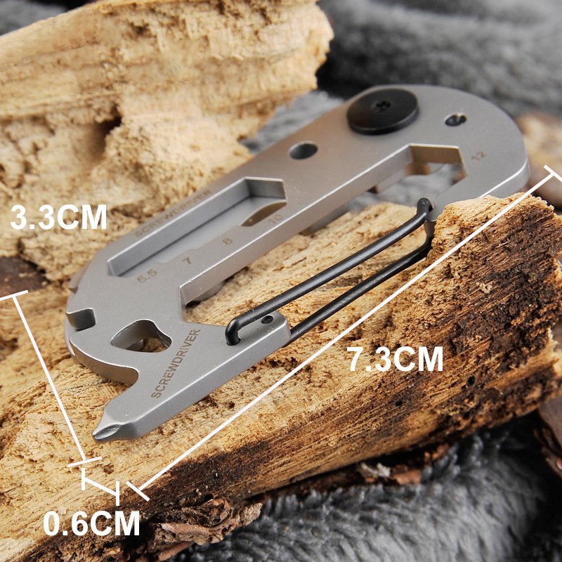 Fuchsia Molly 14-in-1 outdoor camping multi tool with various stainless steel tools displayed on a camping table.