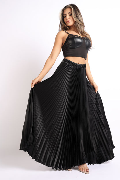 Black satin maxi skirt with high waist and pleated A-line design by Puce Juniper, shown with flowing fabric and elegant style.