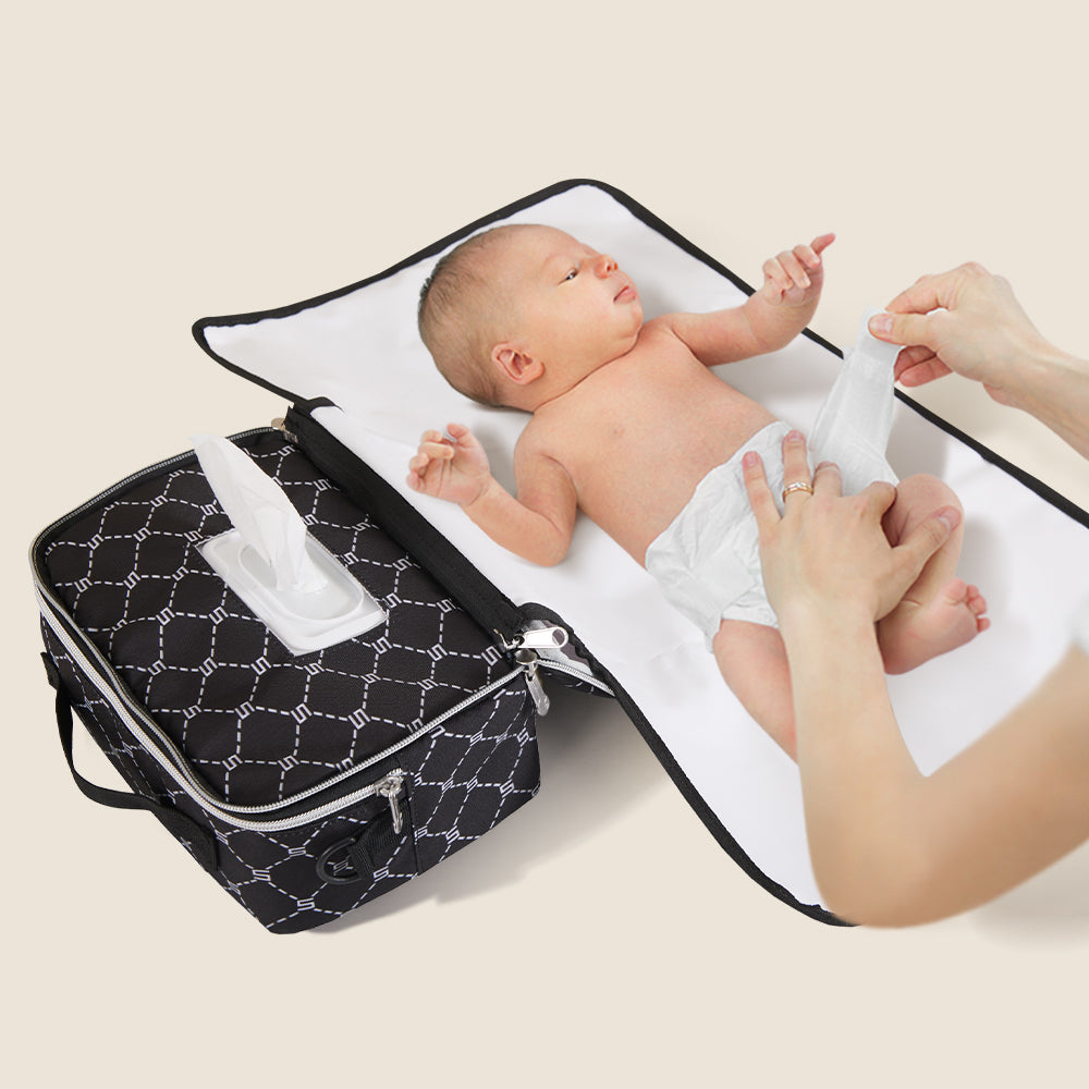 Maroon Chronos all-in-one diaper bag with changing pad, featuring multiple compartments and adjustable straps for parent and baby needs.