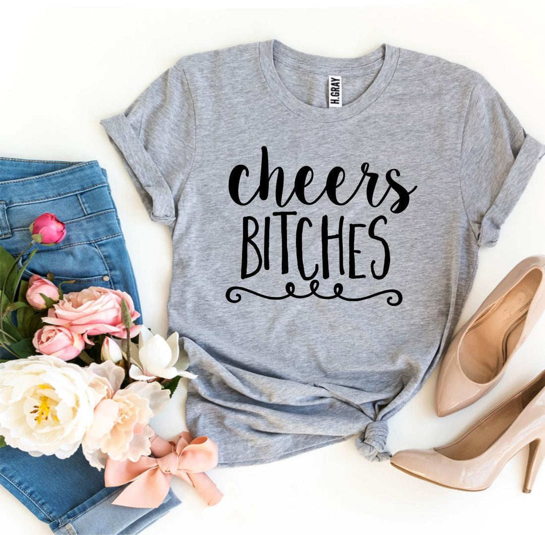 Agate Cheers Bitches T-shirt showing bold text on a casual black T-shirt for women.