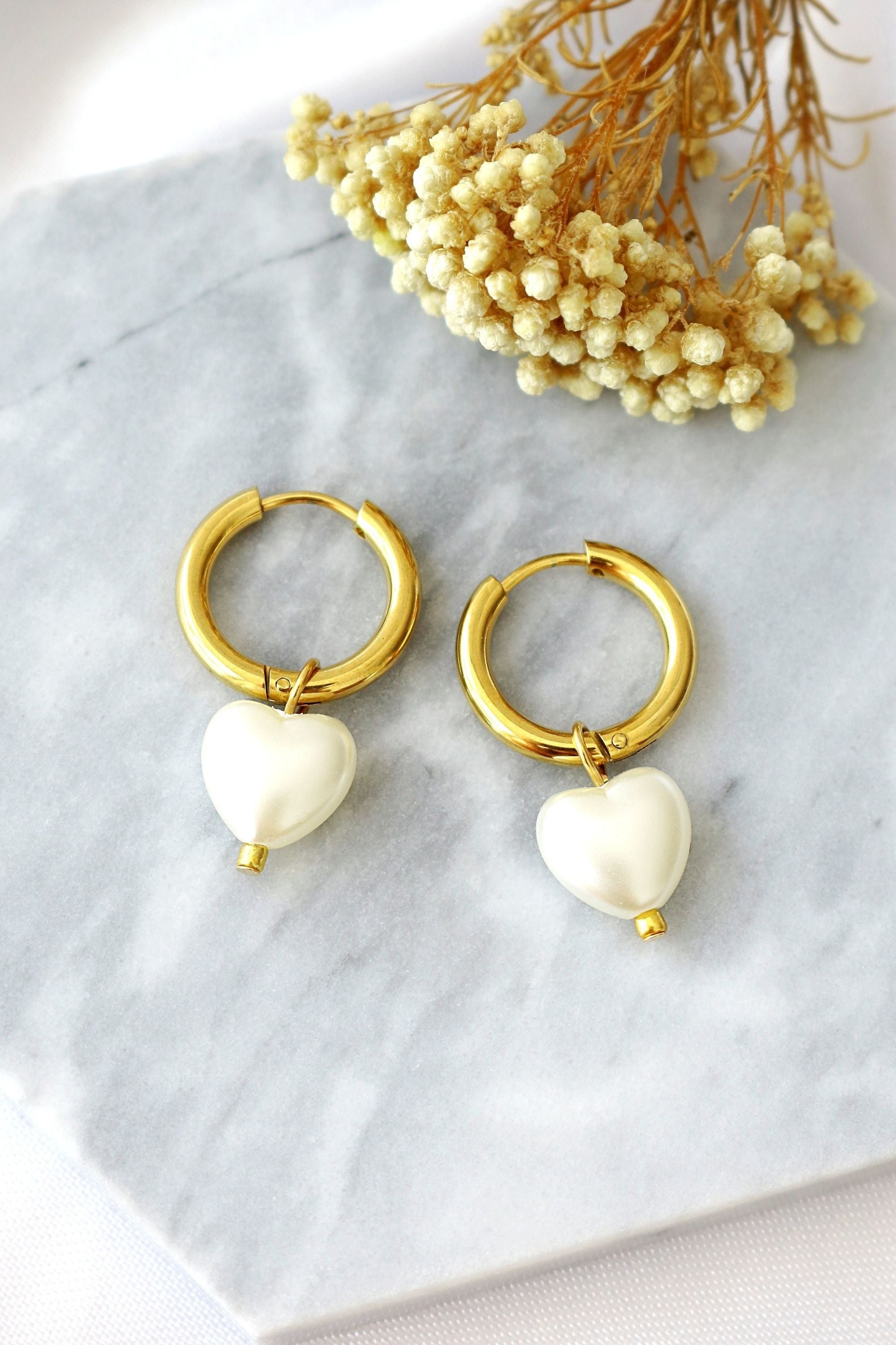 Ultramarine Birch 24K Pearl Hearts Hoop Earrings featuring gold hoops with pearl heart charms, stylish and elegant jewelry accessory.