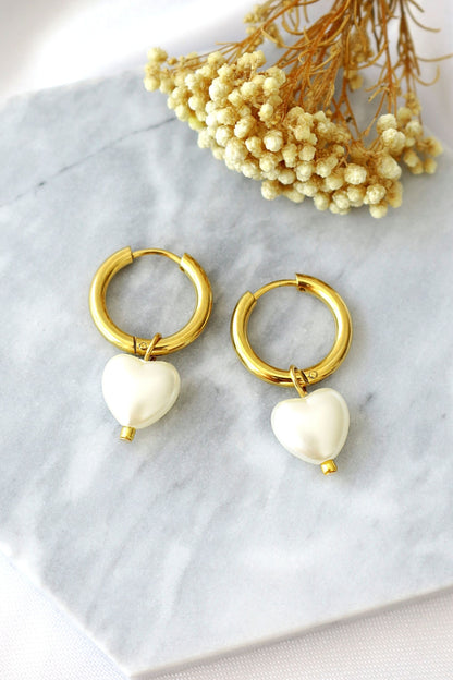 Ultramarine Birch 24K Pearl Hearts Hoop Earrings featuring gold hoops with pearl heart charms, stylish and elegant jewelry accessory.