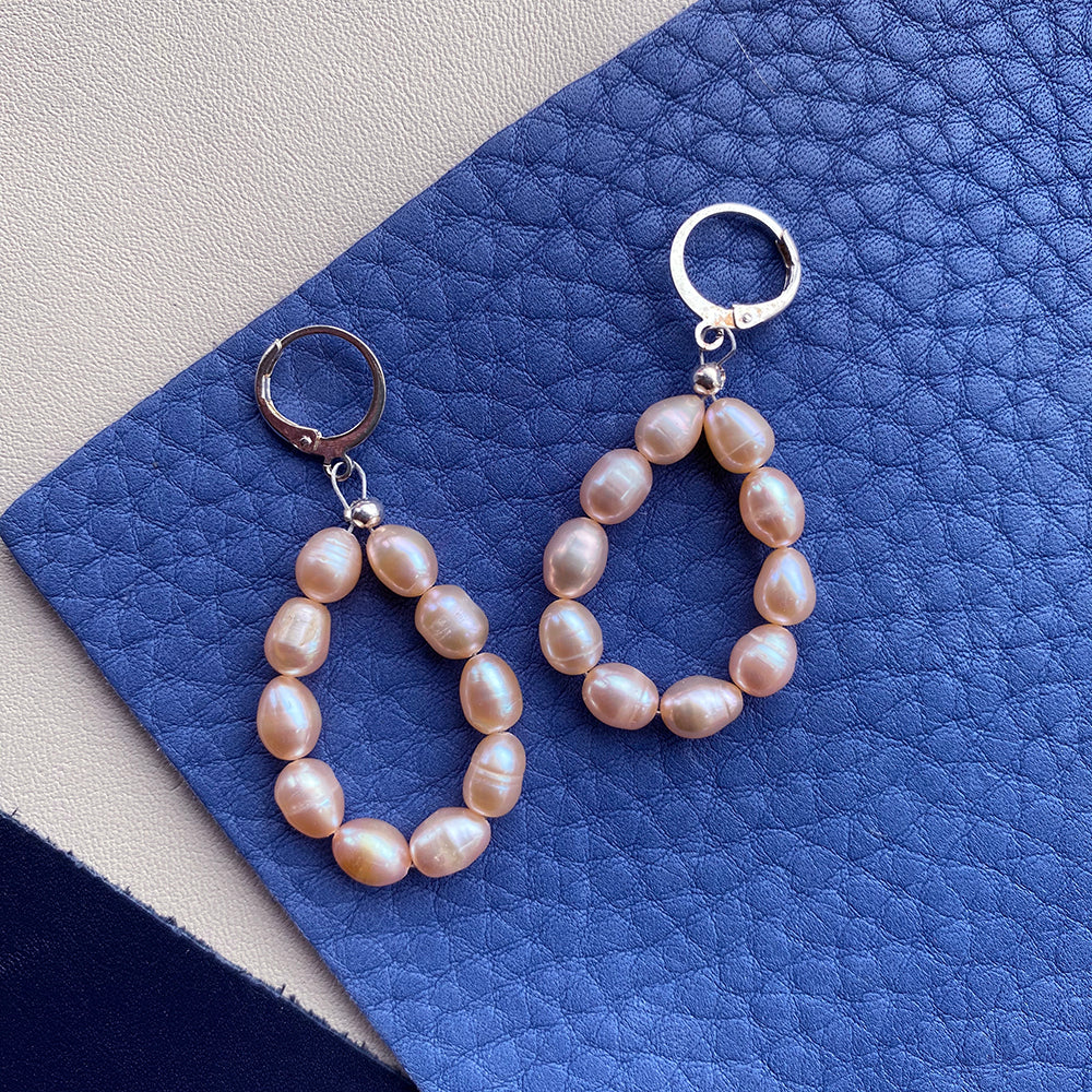 Yellow Athena pearl drop earrings featuring elegant white pearls hanging from gold-tone hooks.