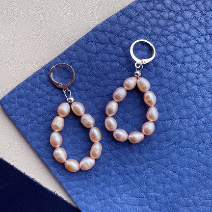 Yellow Athena pearl drop earrings featuring elegant white pearls hanging from gold-tone hooks.