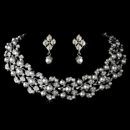 Elegant bridal wedding jewelry set by Olive Chaos featuring crystal, pearl necklace and matching earrings for special occasions.