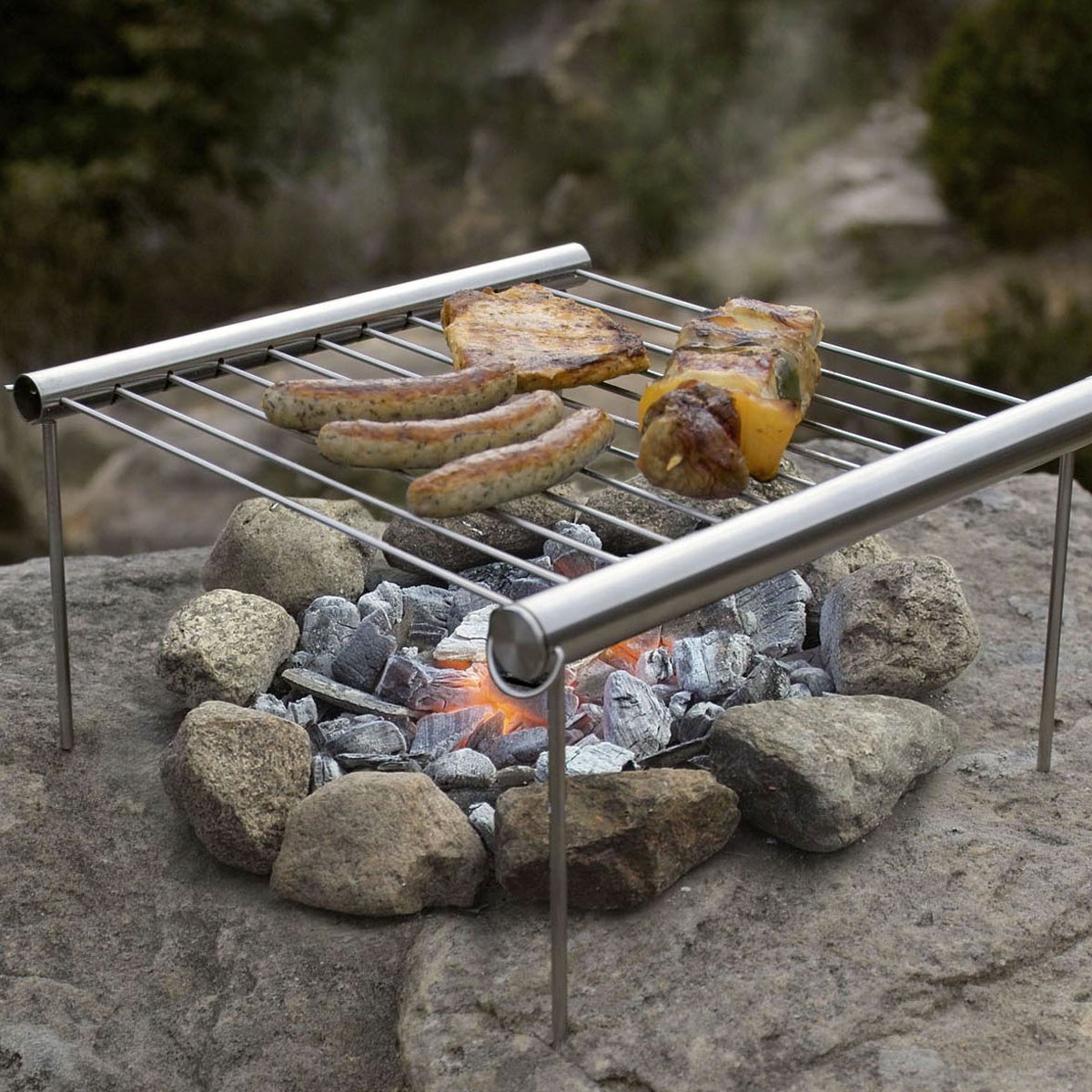 Fuchsia Molly Grilliput portable camping grill with compact design, ideal for outdoor cooking during camping adventures.