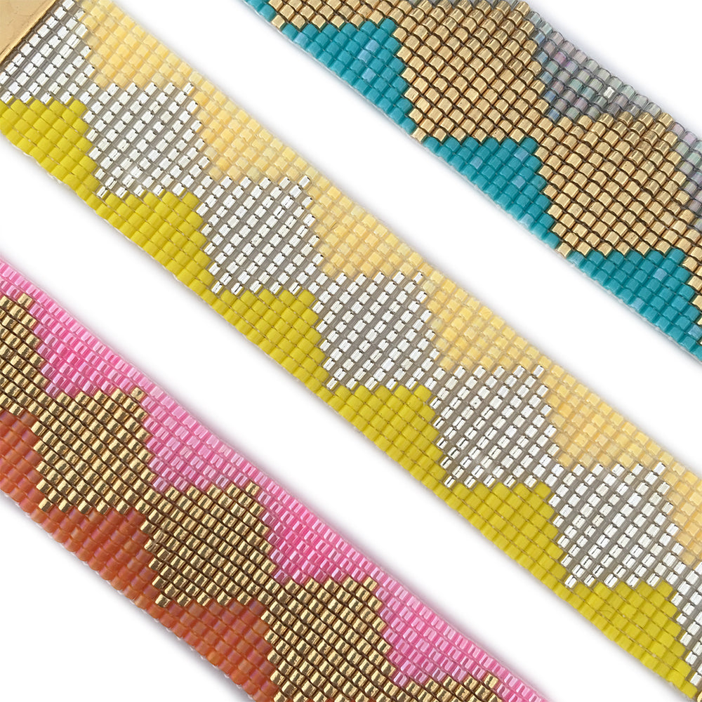 Yellow Athena Soleil bracelets featuring colorful beaded designs on a delicate chain.