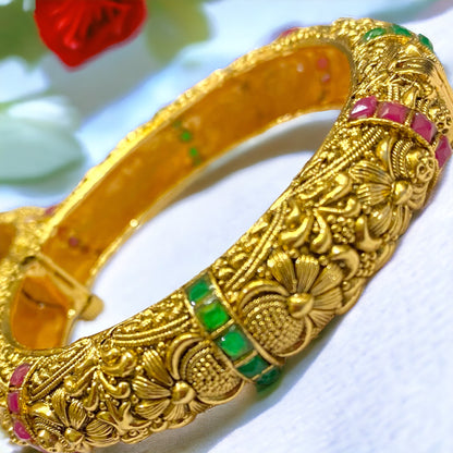 Gold-plated traditional bangles from Gray Poseidon, showcasing intricate design and elegant bracelet style on a neutral background.