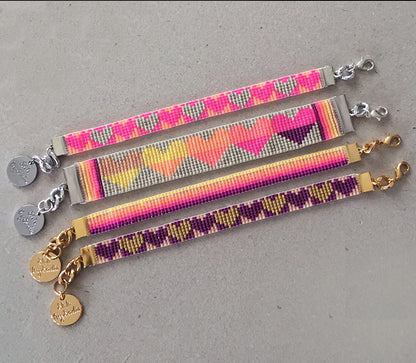 Colorful rainbow heart bracelets by Yellow Athena featuring vibrant heart charms on stretchy band for stylish wear.