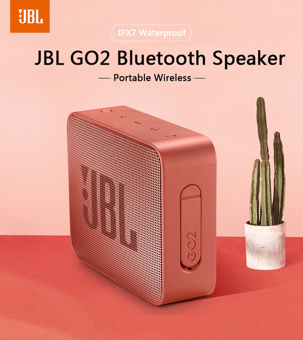 White Eucalyptus waterproof wireless Bluetooth speaker for pets, IPX7 rated, portable JBL GO2 style device in a pet-friendly setting.