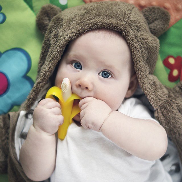 Fuchsia Molly Baby Banana Training Toothbrush as a fun, colorful home decor piece with playful banana design.