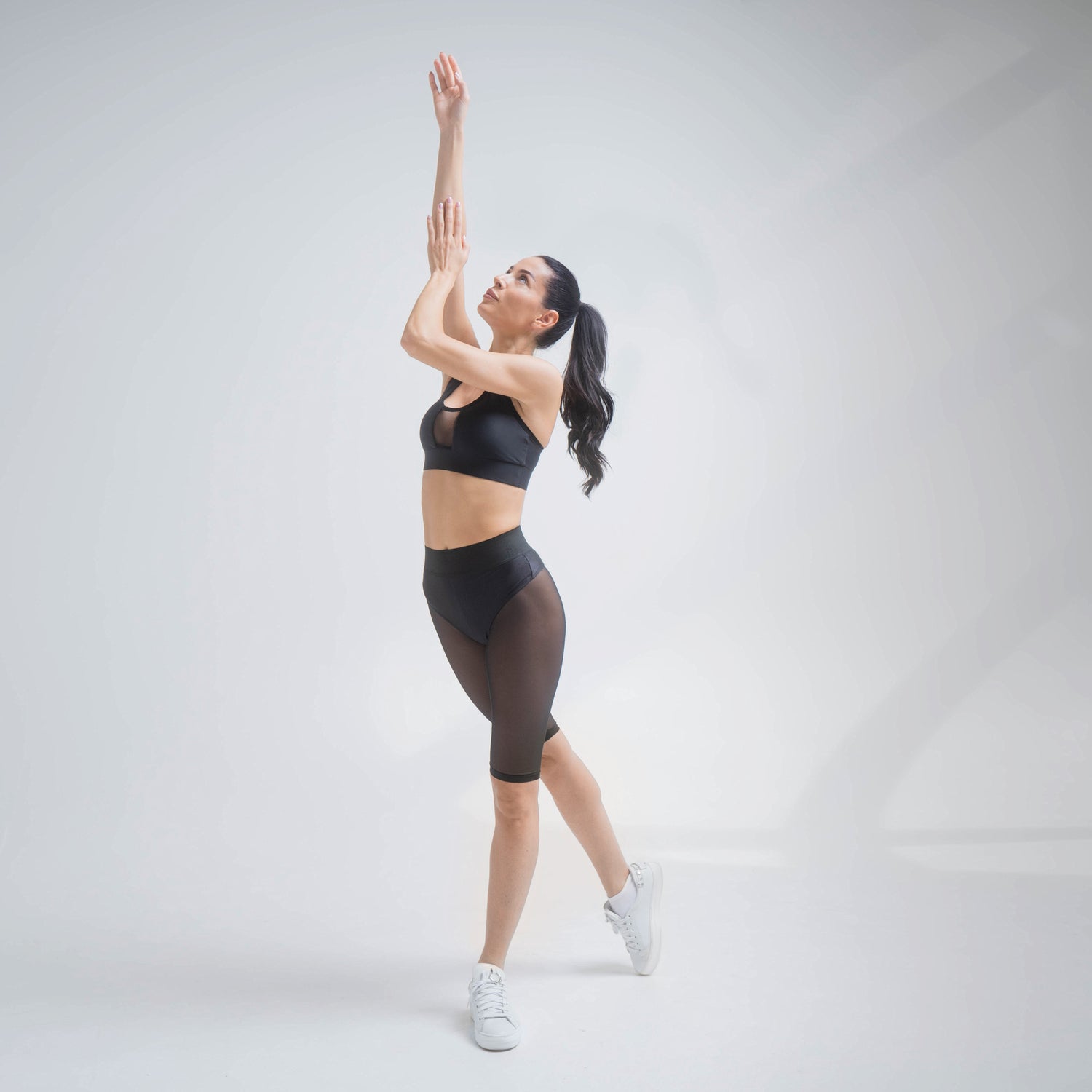 Black mesh shorts by Indigo Thalassa with lightweight, breathable fabric and an elastic waistband, perfect for active wear.