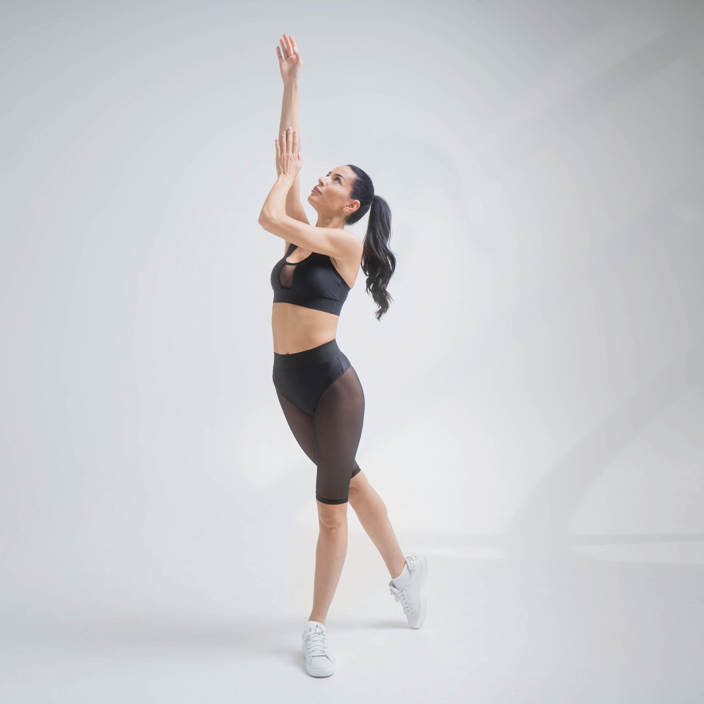 Black mesh shorts by Indigo Thalassa with lightweight, breathable fabric and an elastic waistband, perfect for active wear.