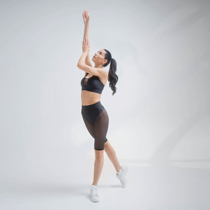 Black mesh shorts by Indigo Thalassa with lightweight, breathable fabric and an elastic waistband, perfect for active wear.