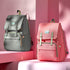Maroon Chronos canvas diaper bag travel backpack with multiple compartments and adjustable straps, designed for parents on the go.