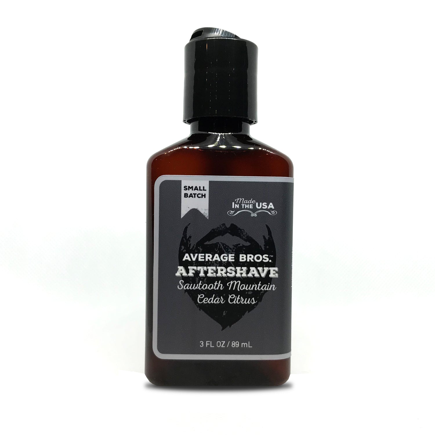 Tan Athena Sawtooth Mountain Cedar Citrus aftershave bottle with citrus and cedar scent, displayed in a sleek, clear bottle.