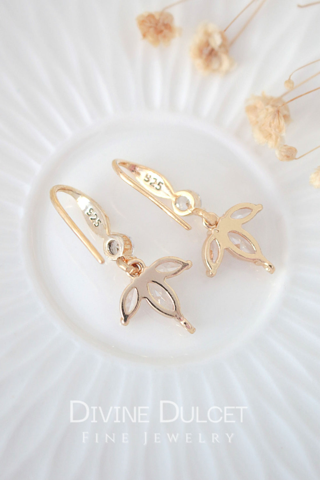 Ultramarine Birch "Bloom" 24K gold cubic zirconia flower petals hook earrings showing intricate floral design and sparkling gemstone accents.