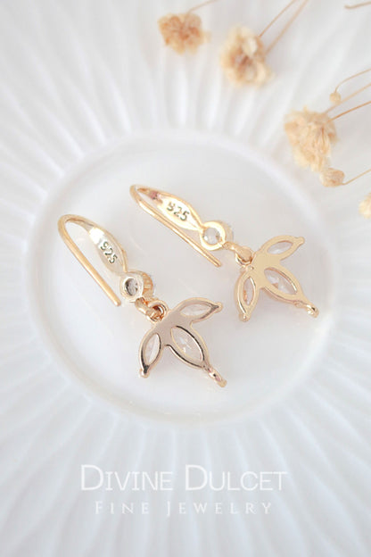 Ultramarine Birch "Bloom" 24K gold cubic zirconia flower petals hook earrings showing intricate floral design and sparkling gemstone accents.