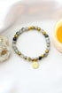 Mossy agate elastic bracelet with 24K gold lotus flower charm, featuring natural stone beads and a stylish, handcrafted design.