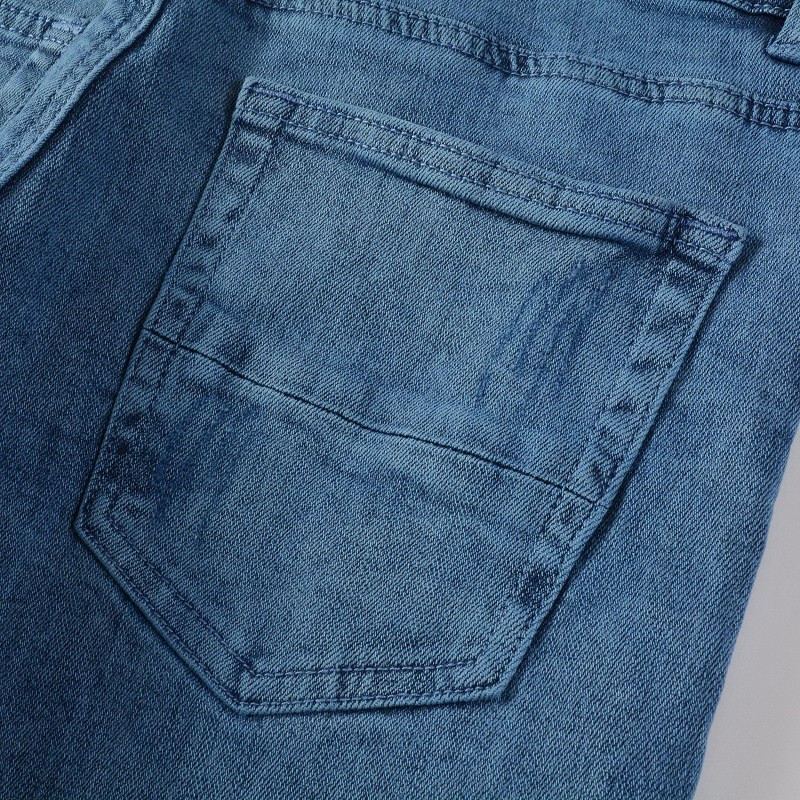 Carmine Juneberry UrbanRift™ distressed mid-waist street jeans, showing faded fabric, rips, and classic denim style.