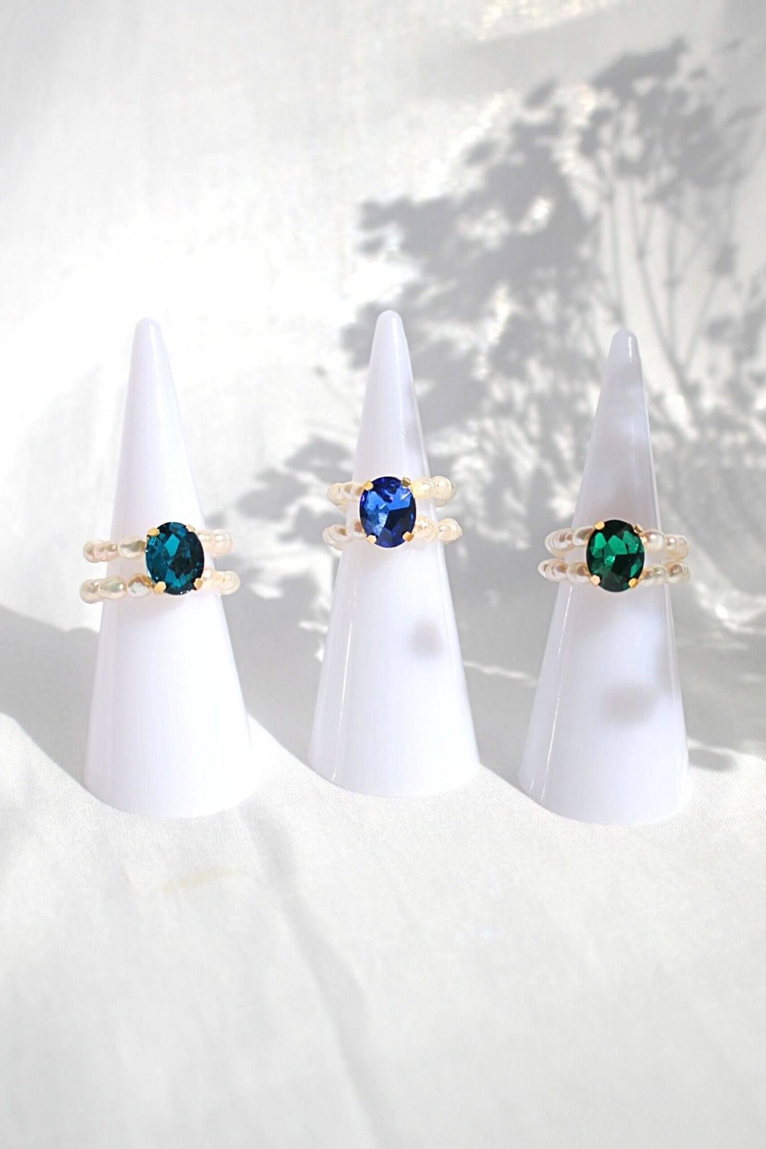 Ultramarine Birch 3 shades blue CZ and freshwater pearl rings featuring elegant band designs and sparkling gemstone accents.