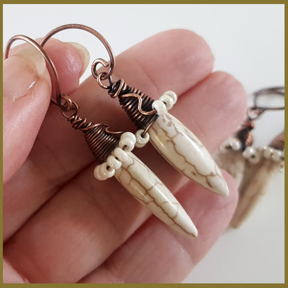 Copper wire wrapped Howlite spike earrings with Maroon Smudge branding, featuring white spike stones and intricate wire details.