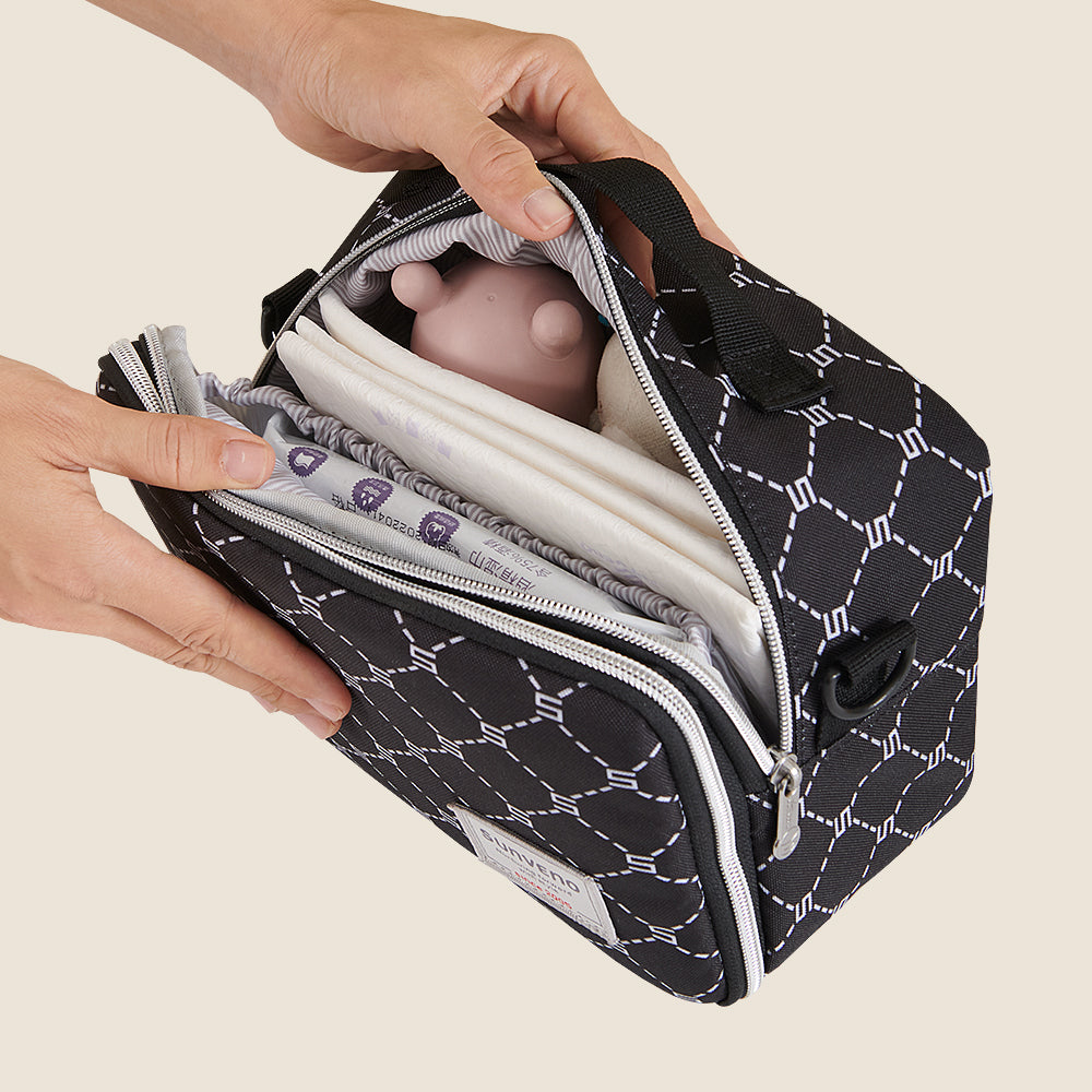 Maroon Chronos all-in-one diaper bag with changing pad, black fabric with multiple compartments for parent and baby essentials.