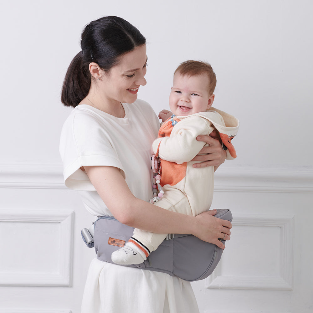 Maroon Chronos fashionable baby hipseat carrier with padded straps and supportive design for parent and baby comfort.