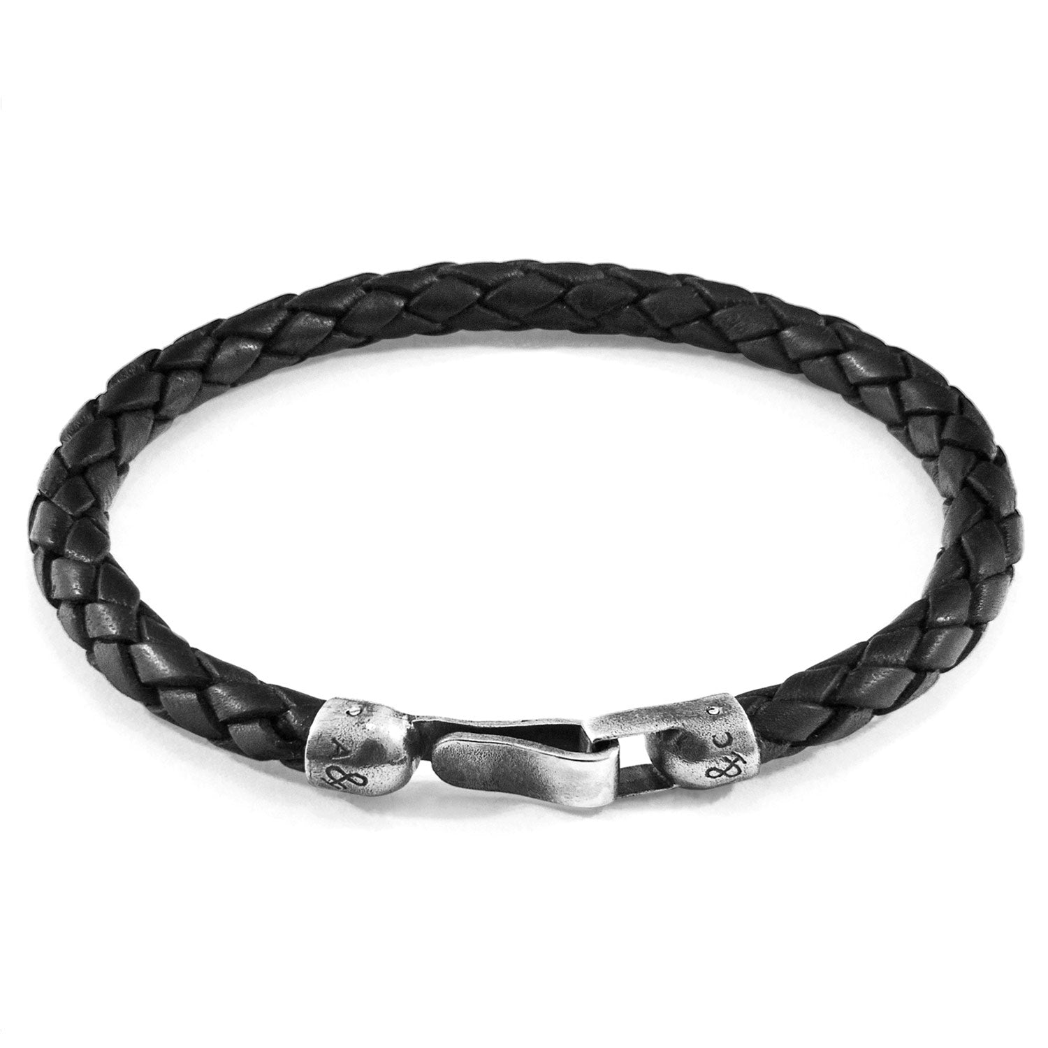 Midnight black Skye silver and braided leather bracelet by Magenta Sooty with silver accents and intricate leather weaving.