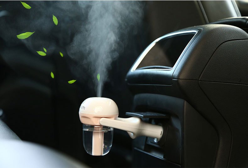Fuchsia Molly Nanum automotive car humidifier mounted on a car dashboard, compact and sleek design for vehicle air quality.