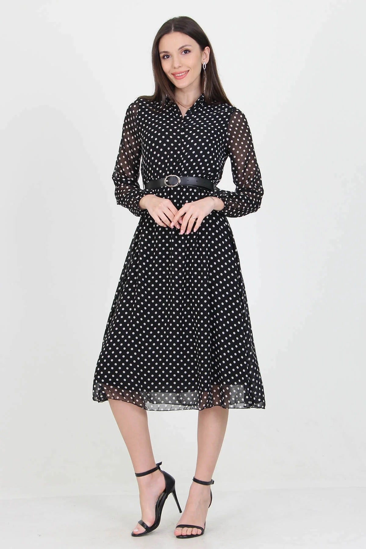 Black Polka Dot Dress by Aquamarine Felix featuring a fitted silhouette and classic polka dot pattern on flowing fabric.