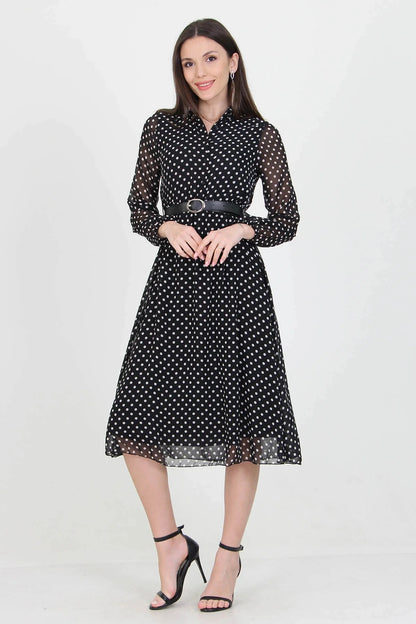 Black Polka Dot Dress by Aquamarine Felix featuring a fitted silhouette and classic polka dot pattern on flowing fabric.